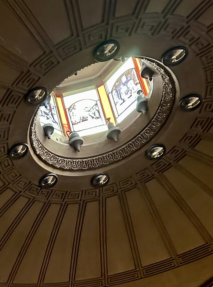 Domed ceiling with stained glass surrounded by mirrors