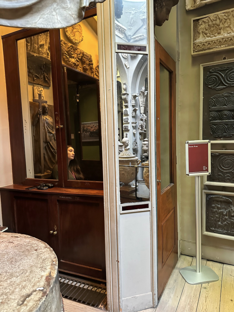 Hallway with mirrored door cabinet and mirrors on small angled wall