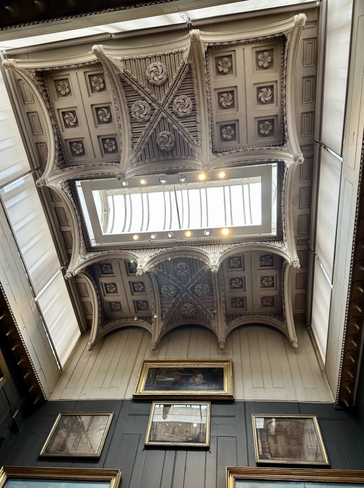 Ornate tall coffered ceiling with large rectangular curved skylight