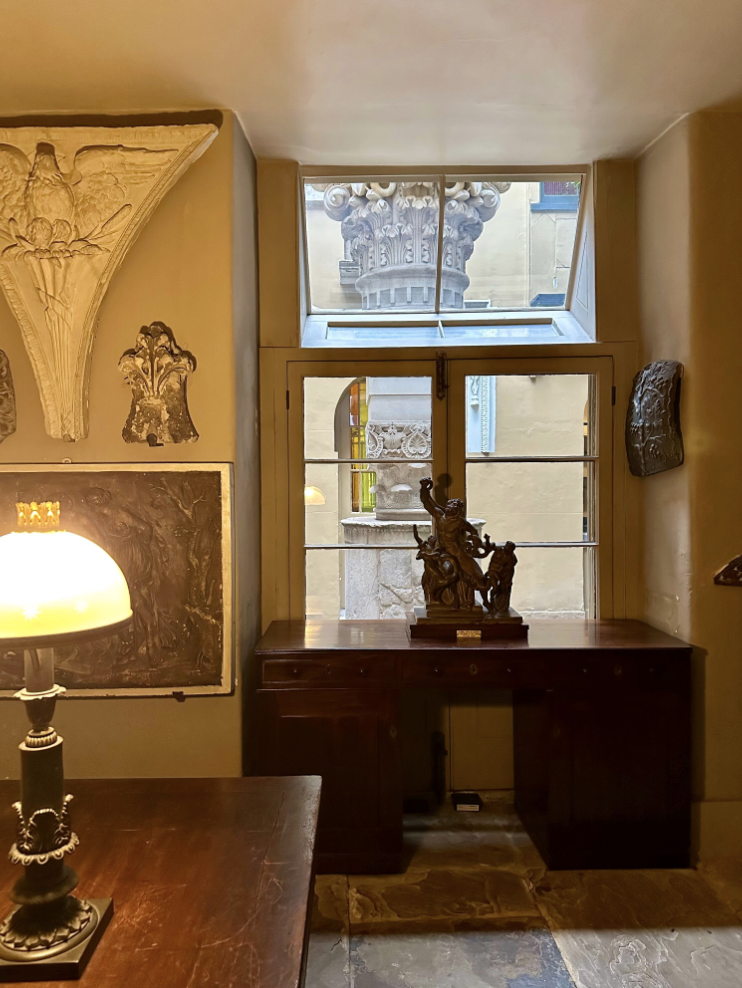 Room with window onto enclosed courtyard.