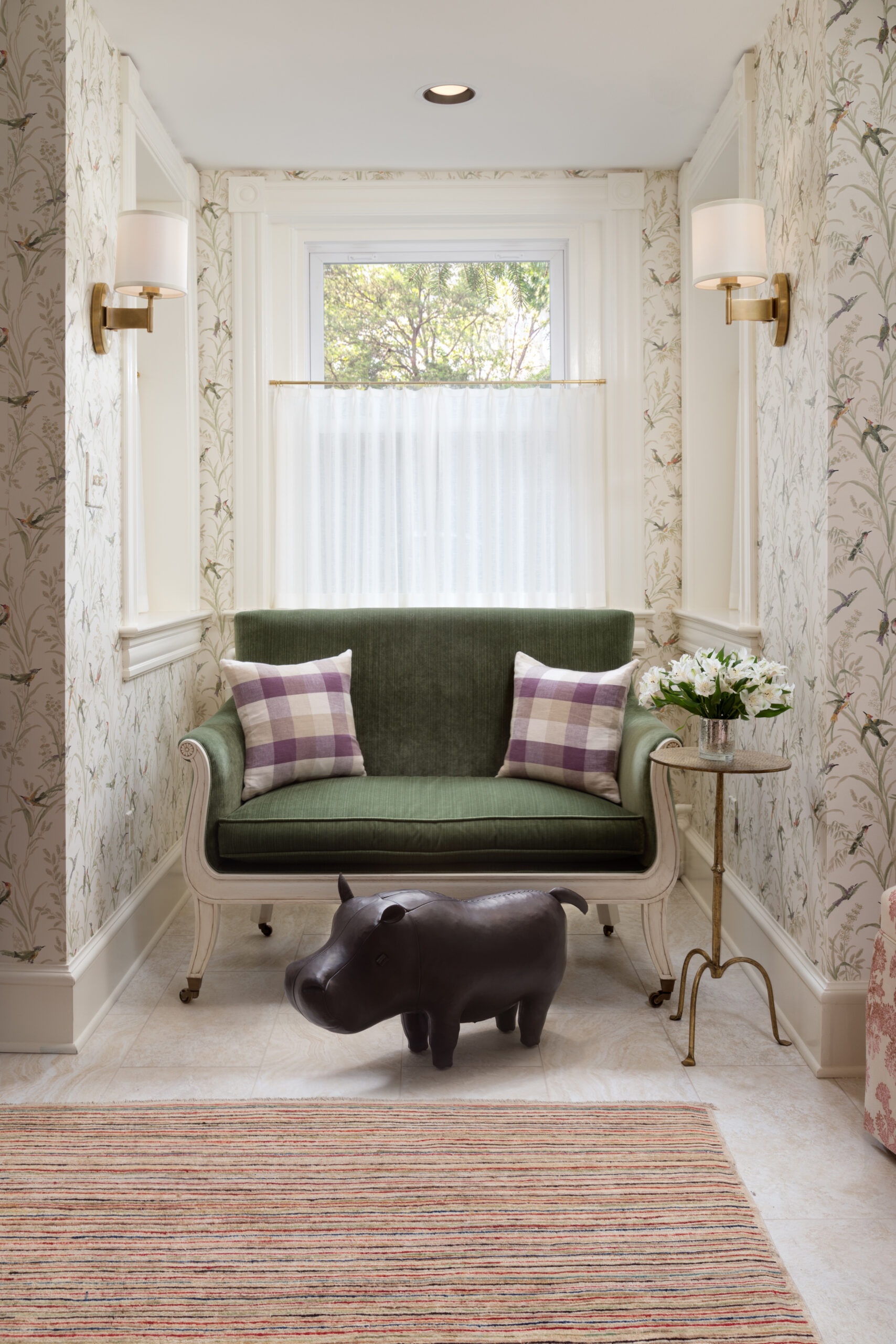 Sitting area with cafe curtain, sofa, and hippo footstool