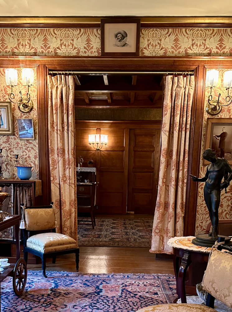 Victorian room with drapes curtains between rooms in a door frame.