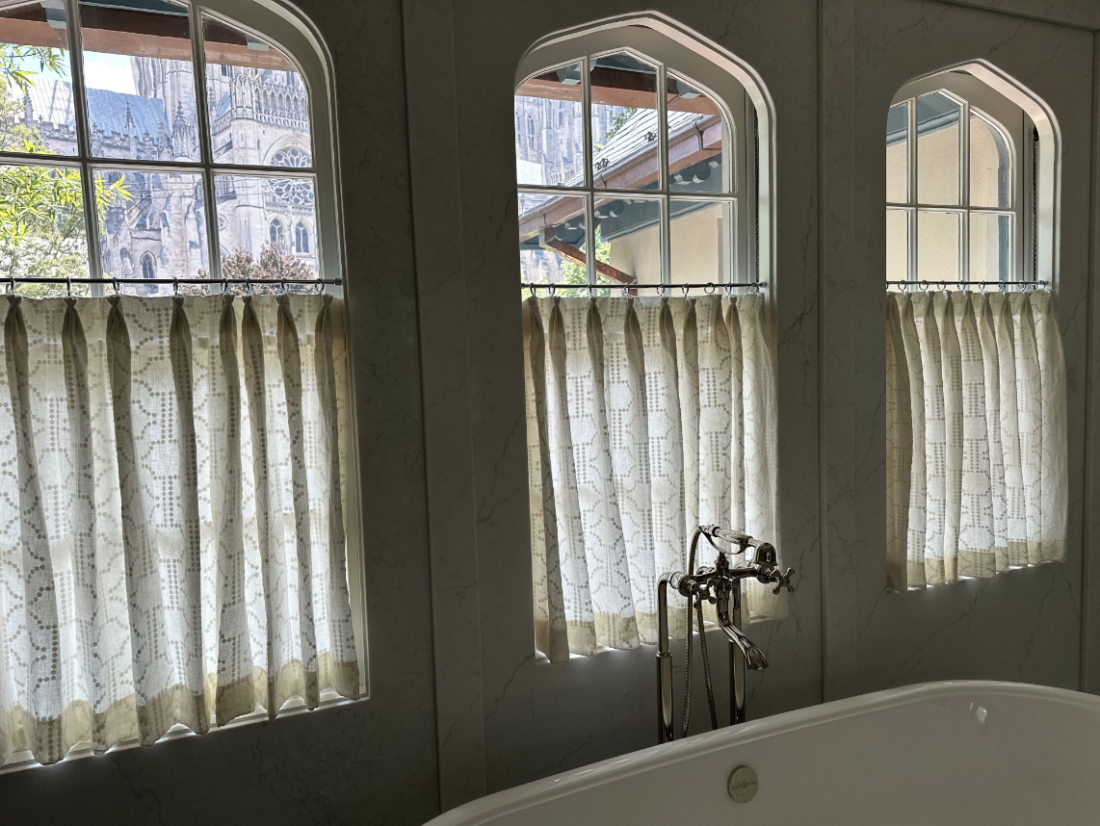 Cafe curtains in a bathroom over a bathtub