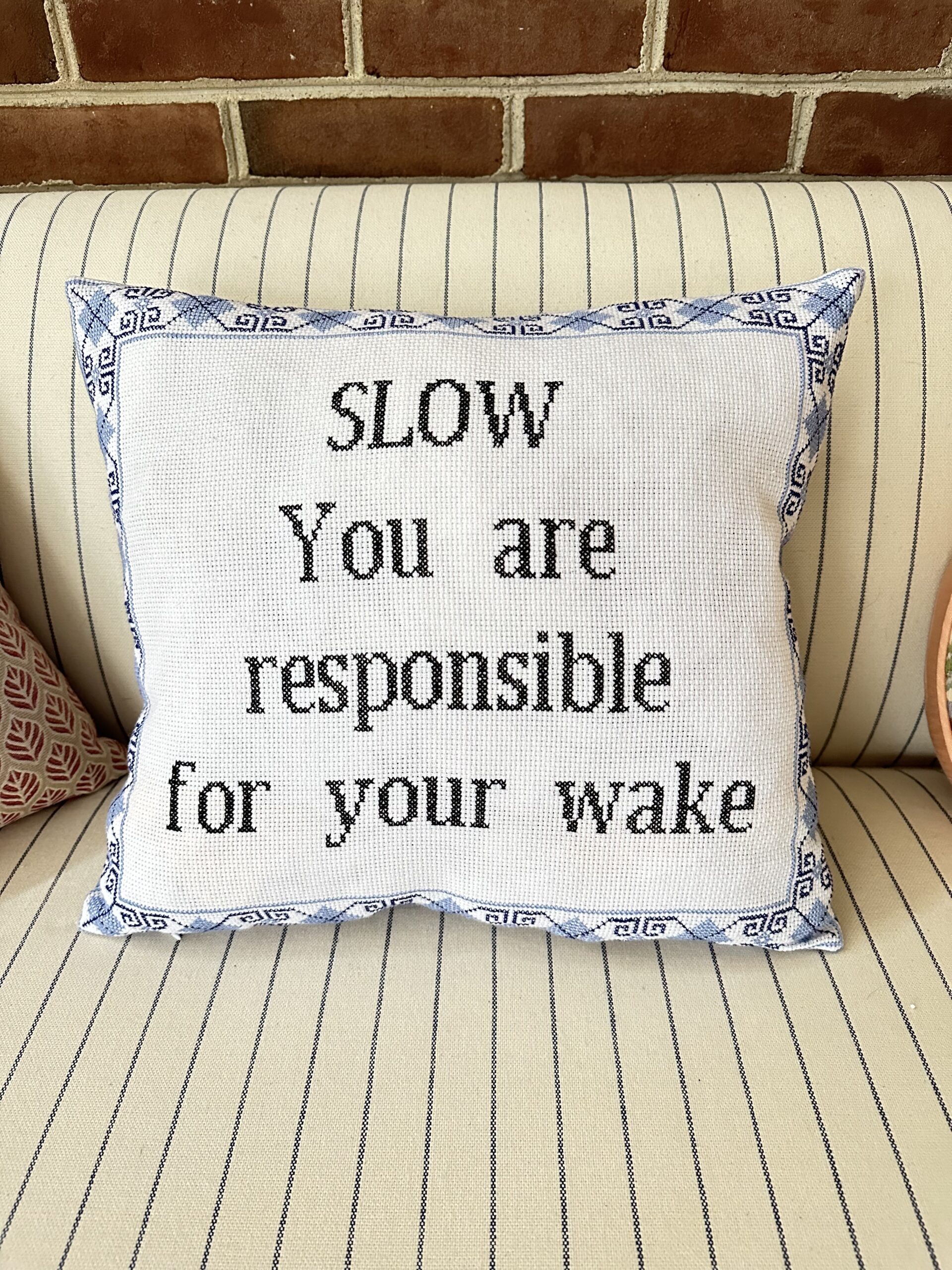 Pillow that says "SLOW. You are responsible for your wake."