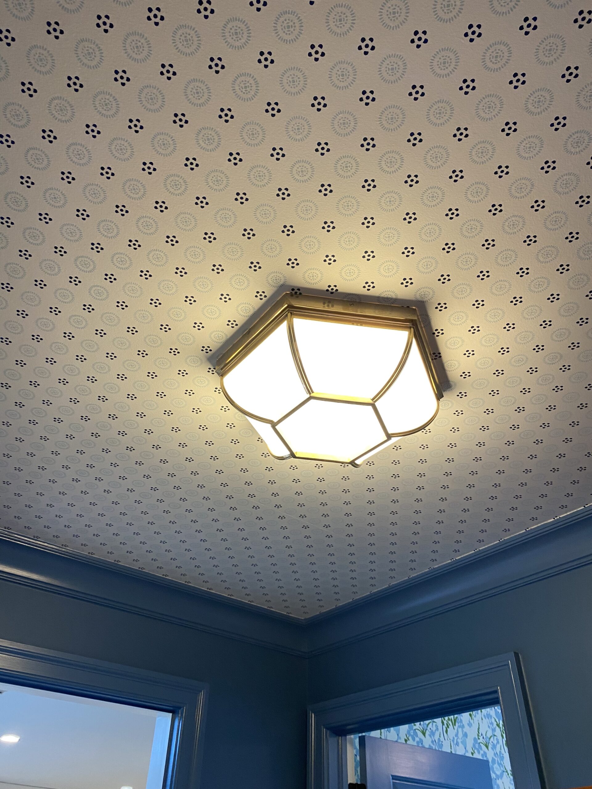 Blue and white wallpaper on a ceiling.