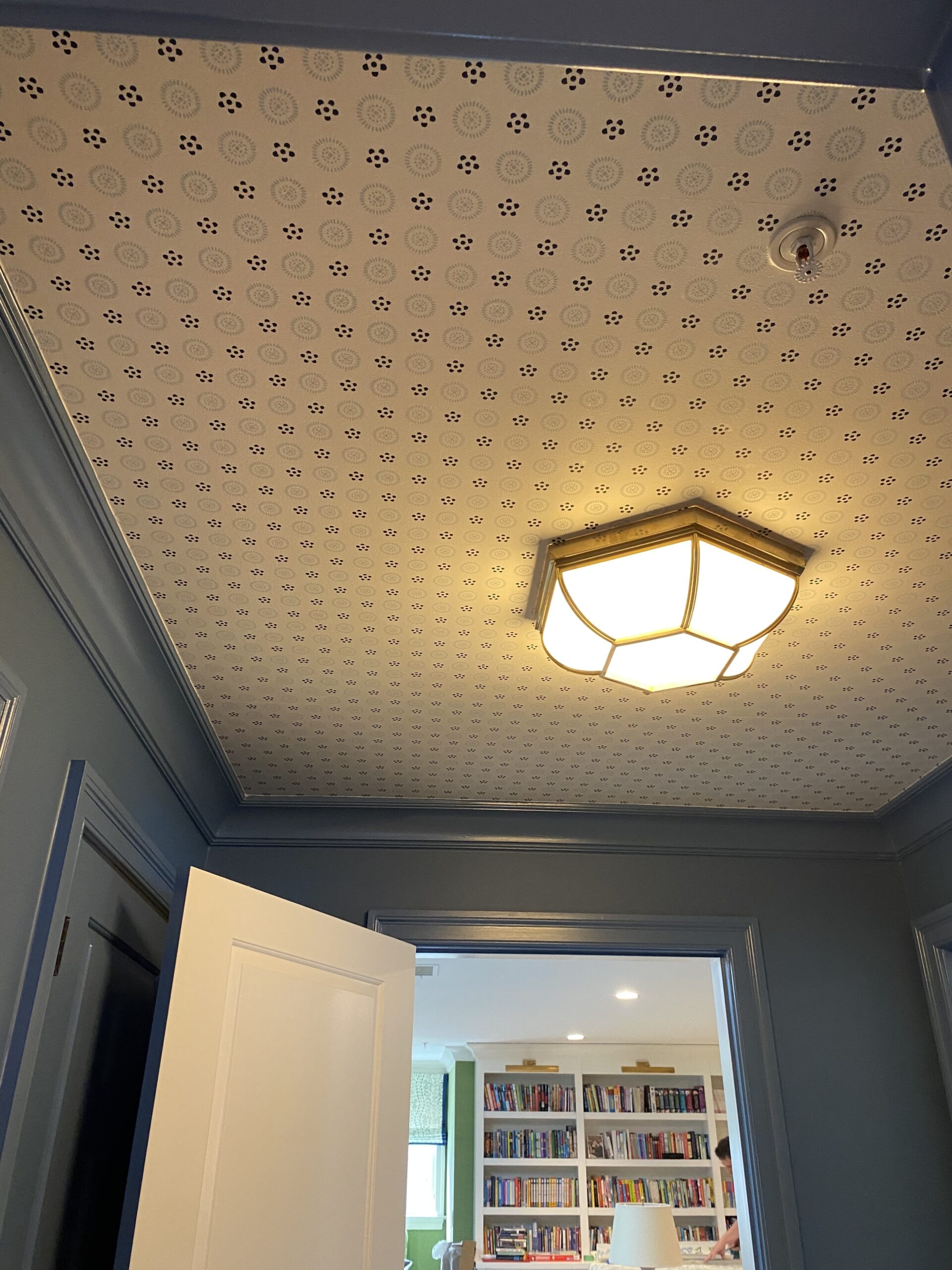 Blue and white wallpaper on a ceiling.