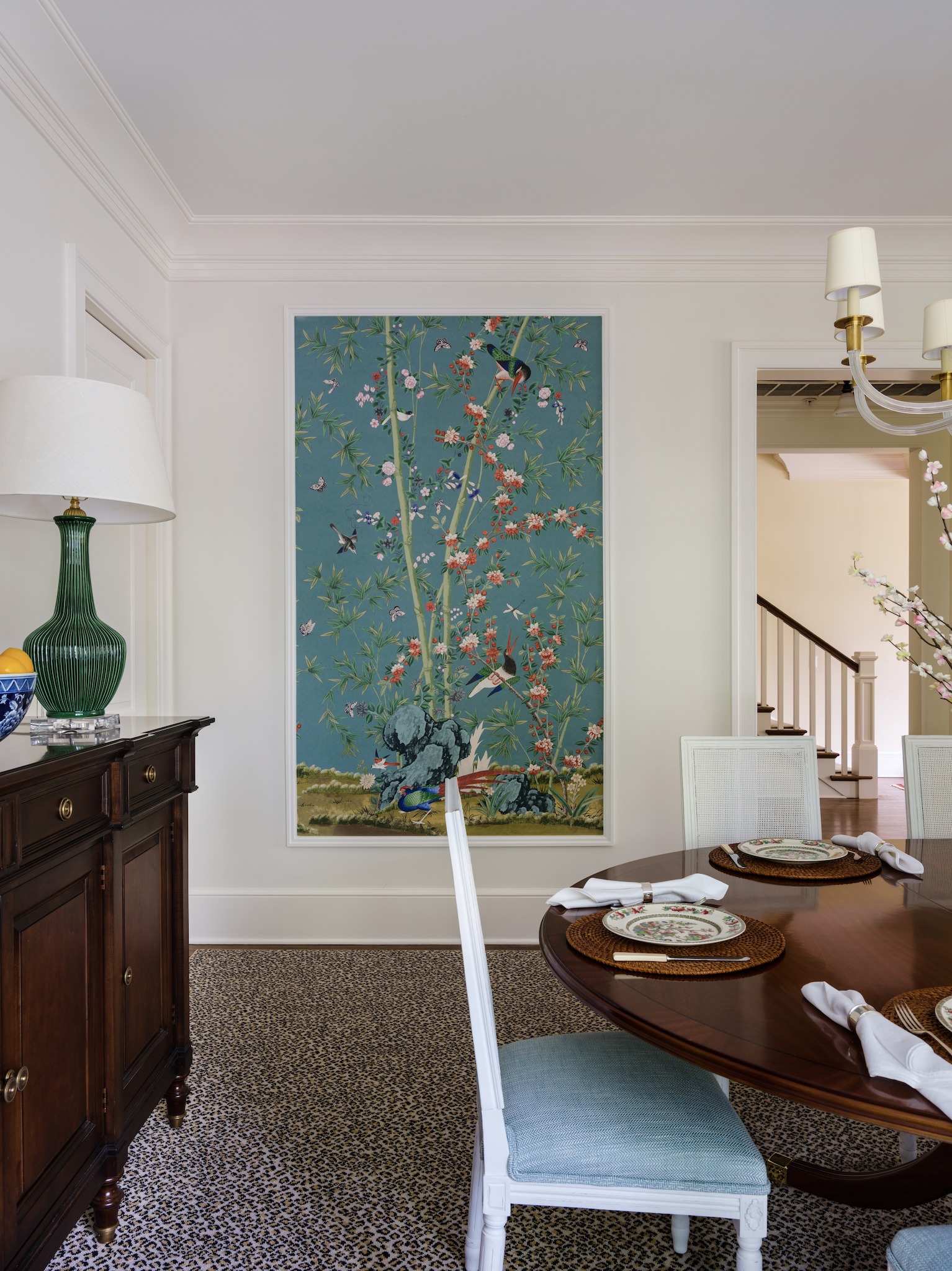 Panel of blue and green whimsical wallpaper framed like artwork.