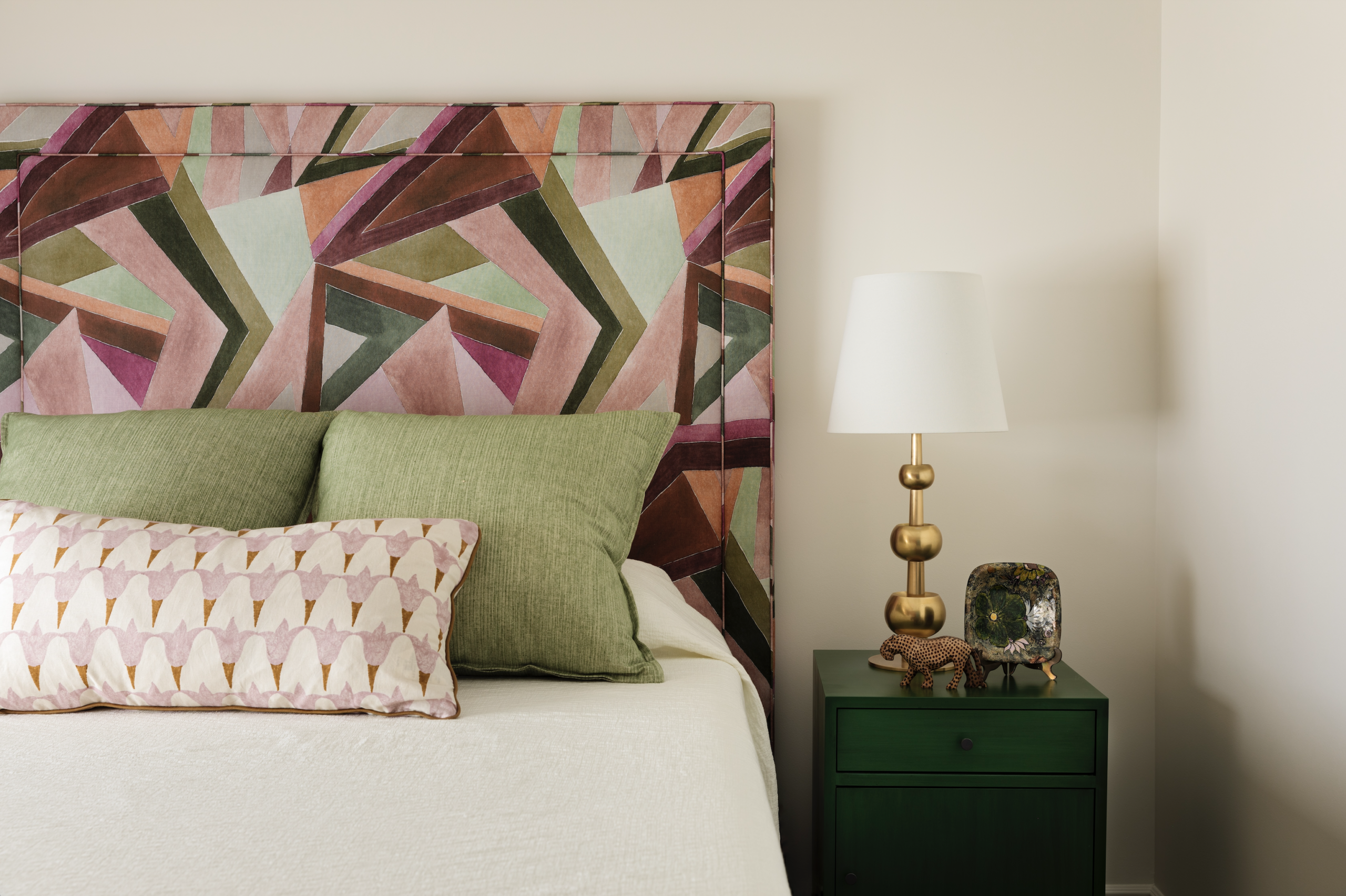Purple, green and pink bed frame, green beside table.