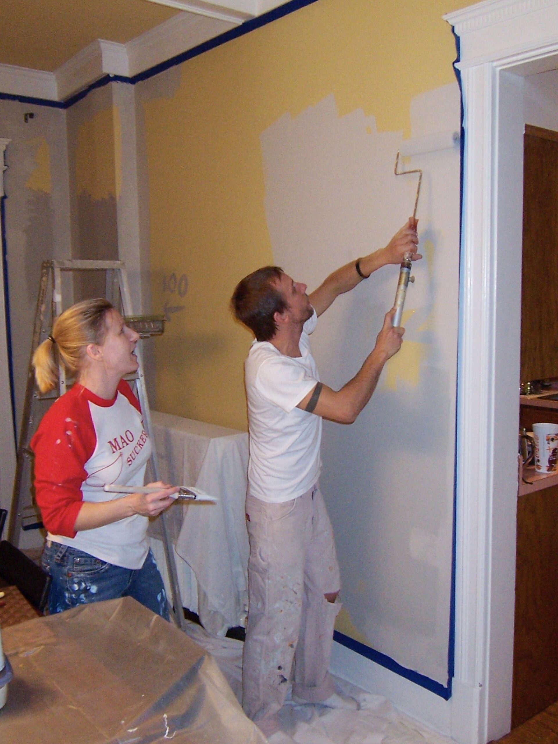 Man and woman painting a room