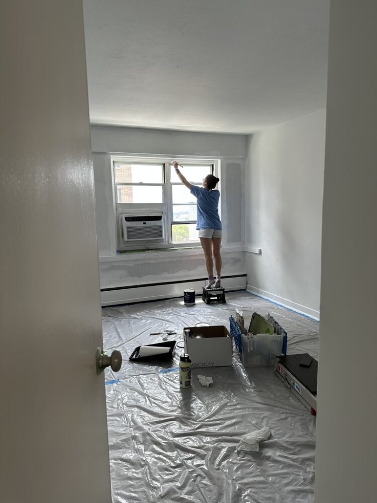 Woman painting a white room