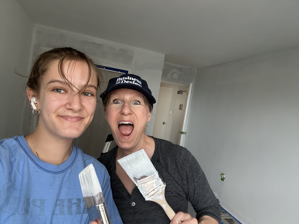 Mom and daughter holding paintbrushes