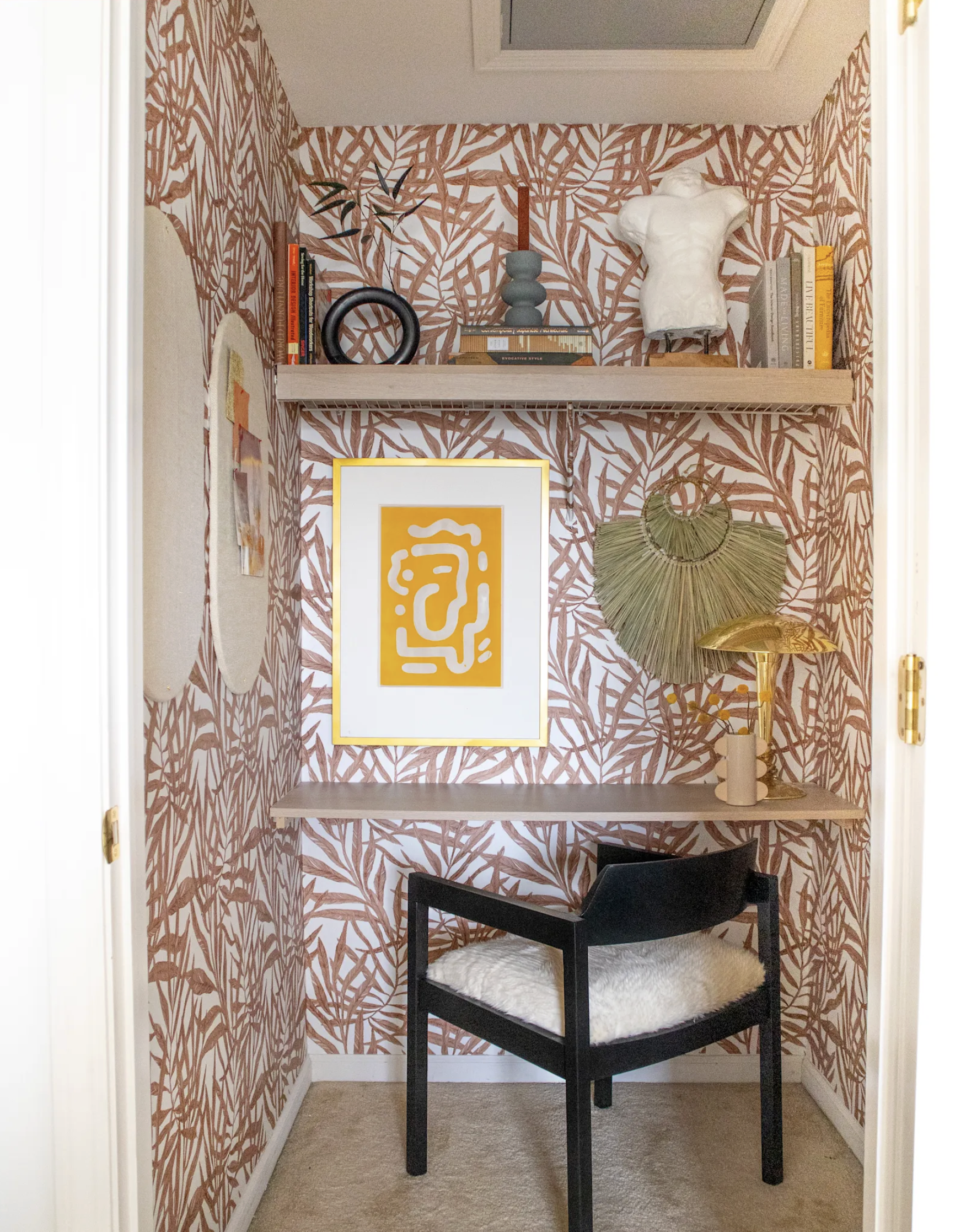 Red and white wallpaper in small home office.