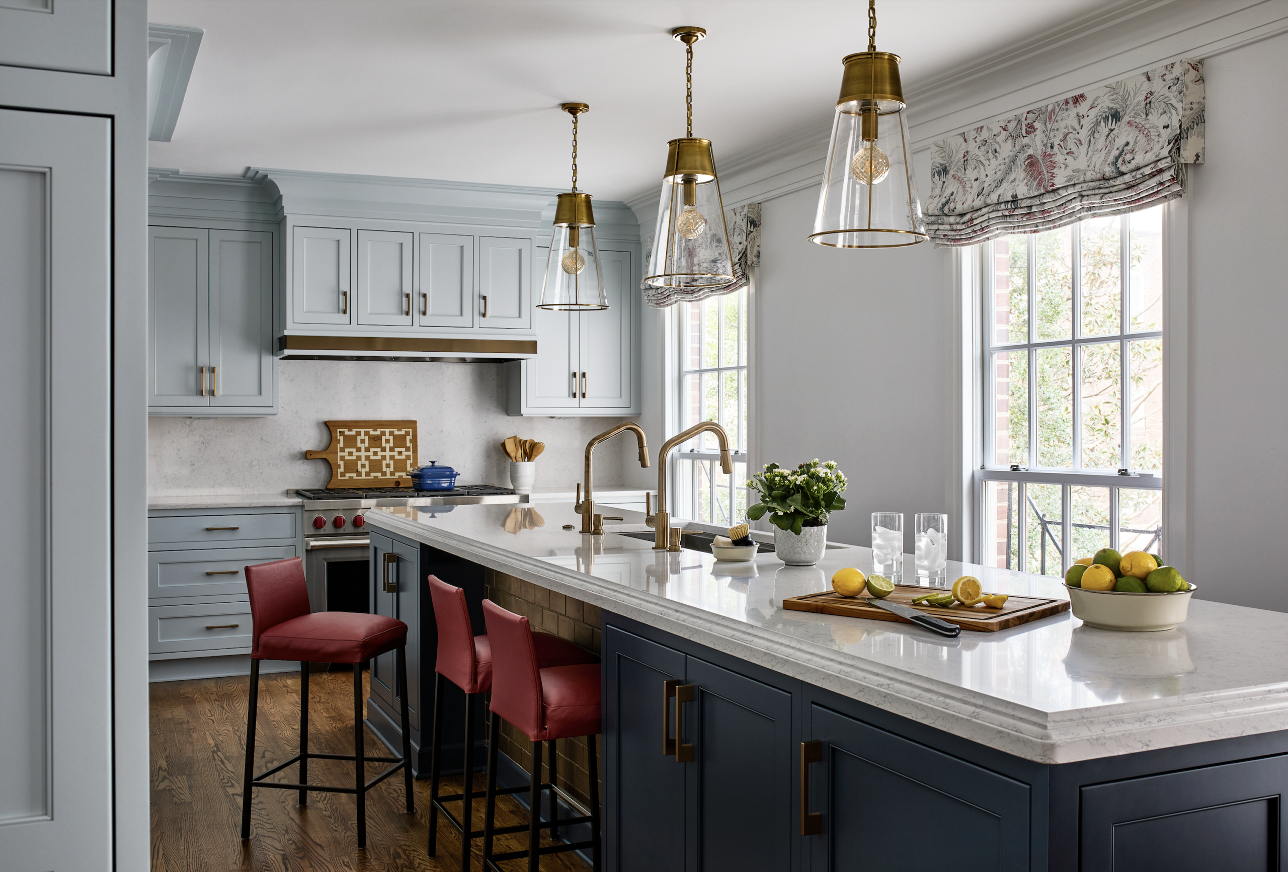 Kitchen with blue cabinets and tile below the island counter.