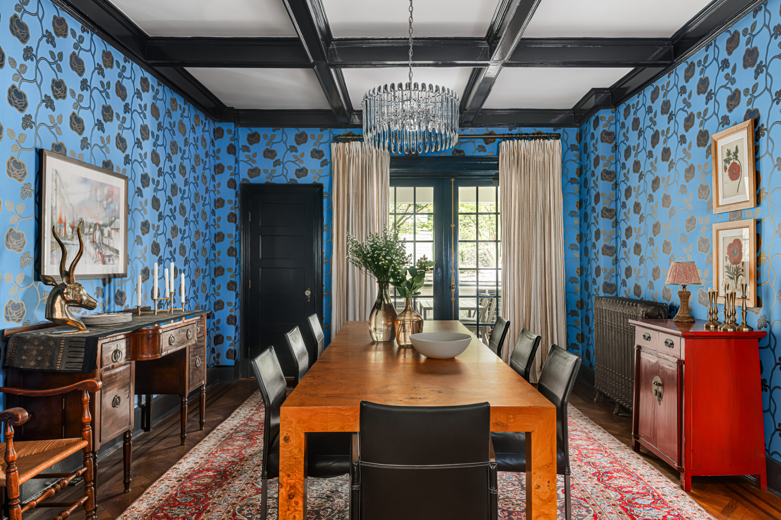 Dining room with blue floral patterned walls and glossy trim