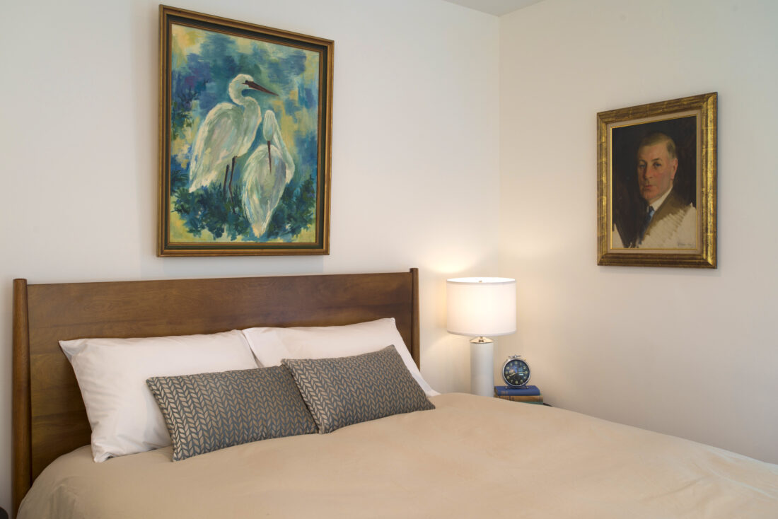 White bedroom with artwork
