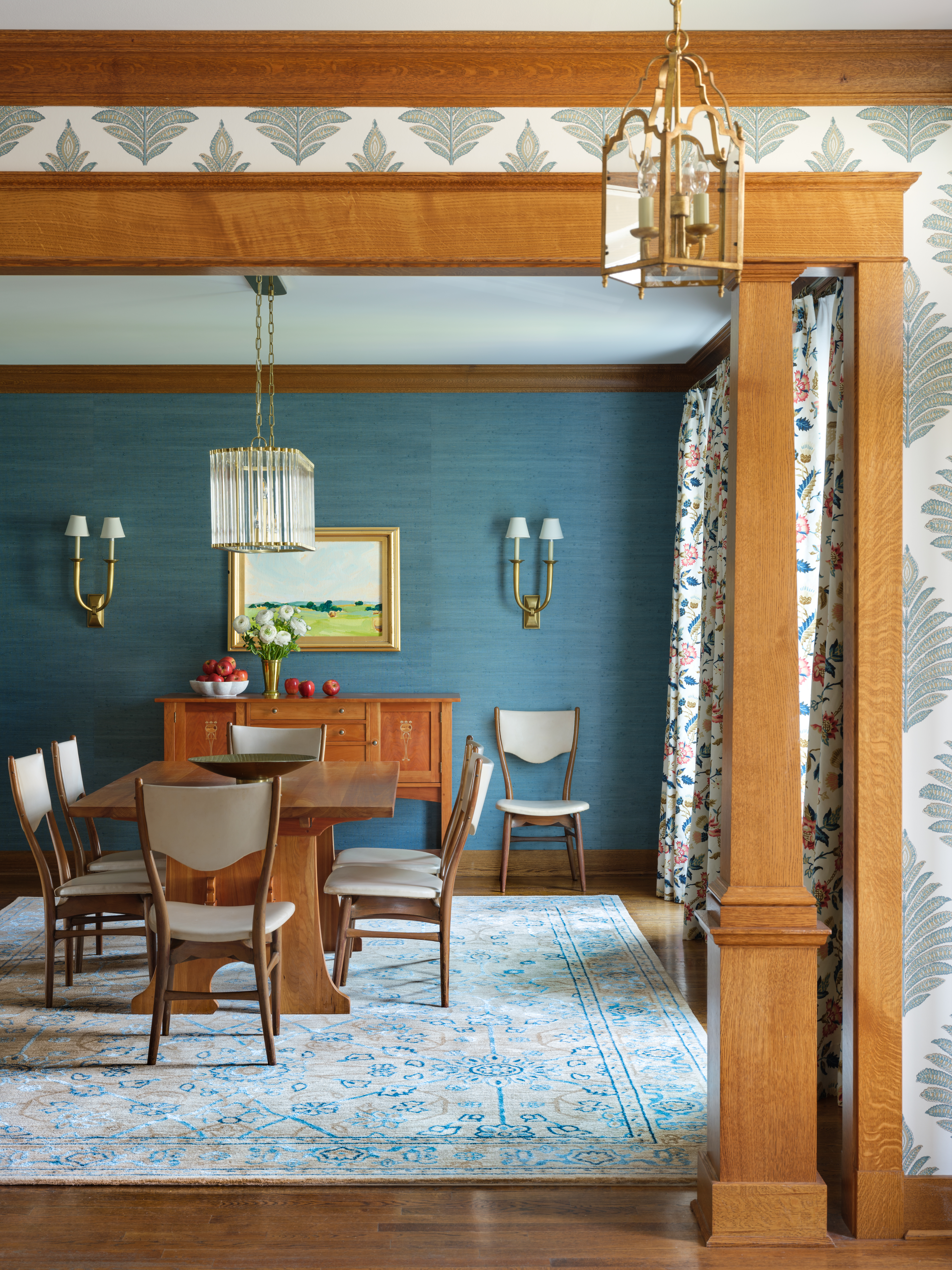 Blue dining room and wallpapered foyer