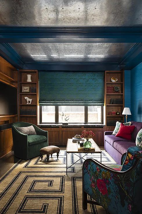 Moody room with wood bookcases and blue walls