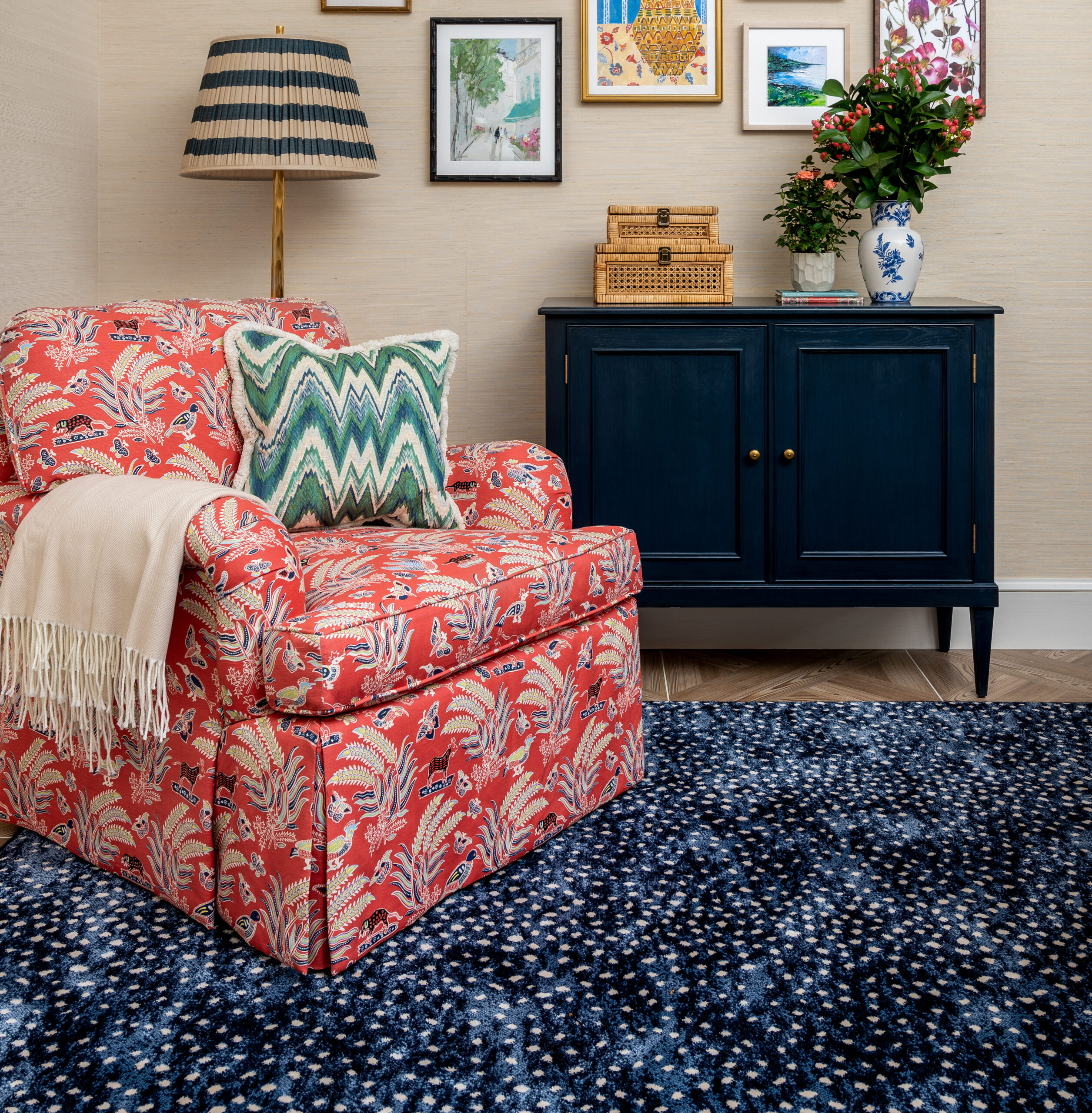 Skirted red patterned chair on navy and white rug