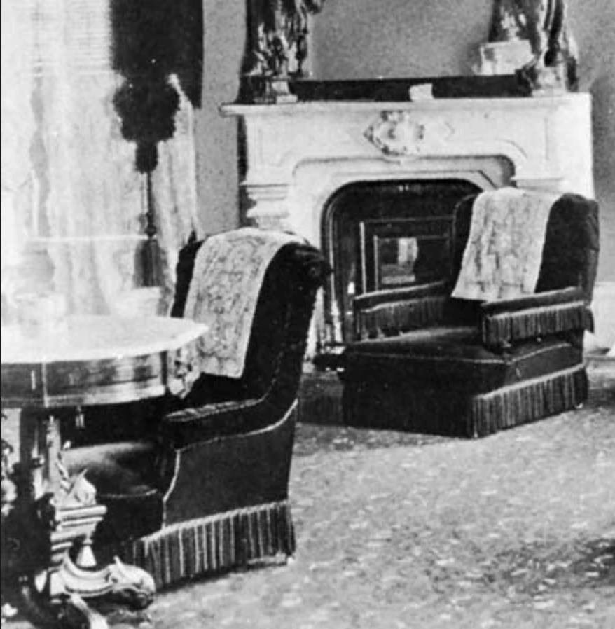 Two ruffled chairs with white antimacassars