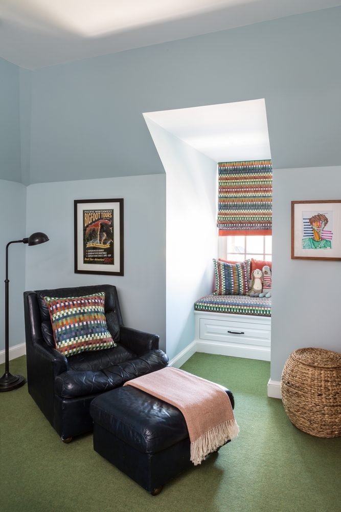 Light blue bedroom with window seat and stuffed animals