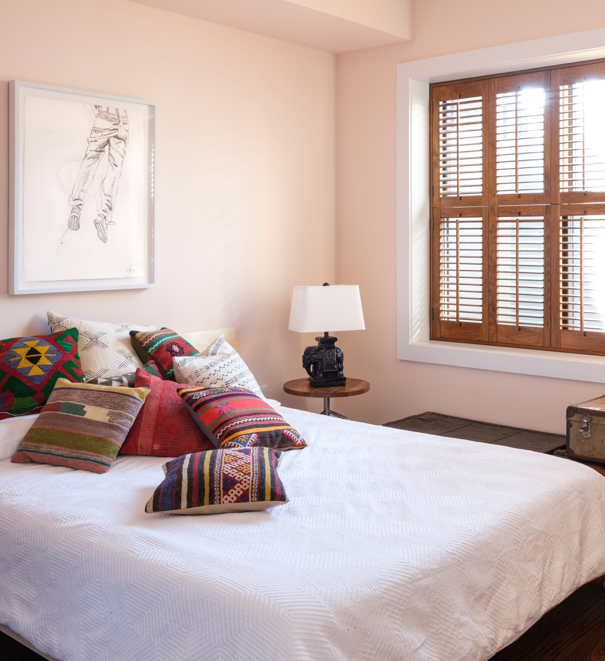 Bedroom with many Moroccan pillows on the bed