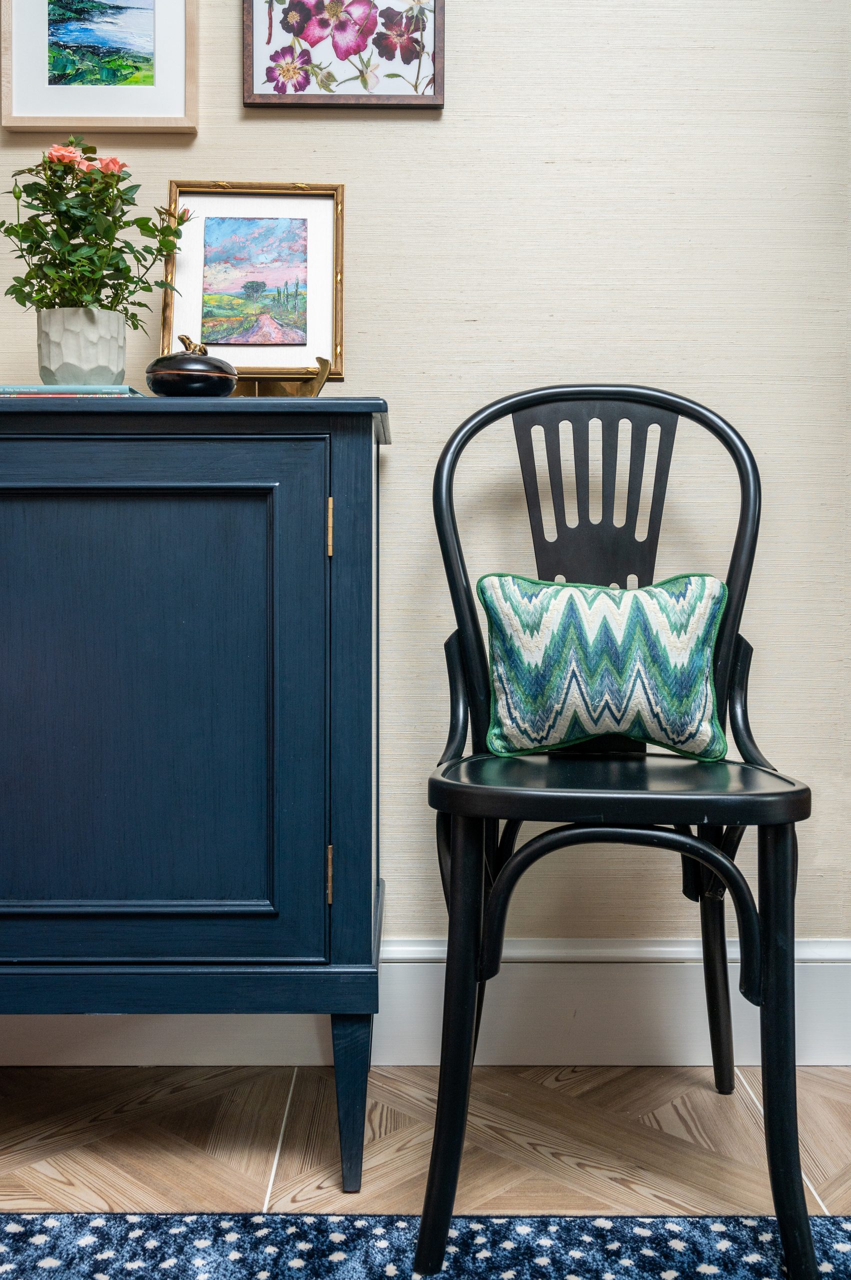 Wooden black chair with small lumbar pillow.