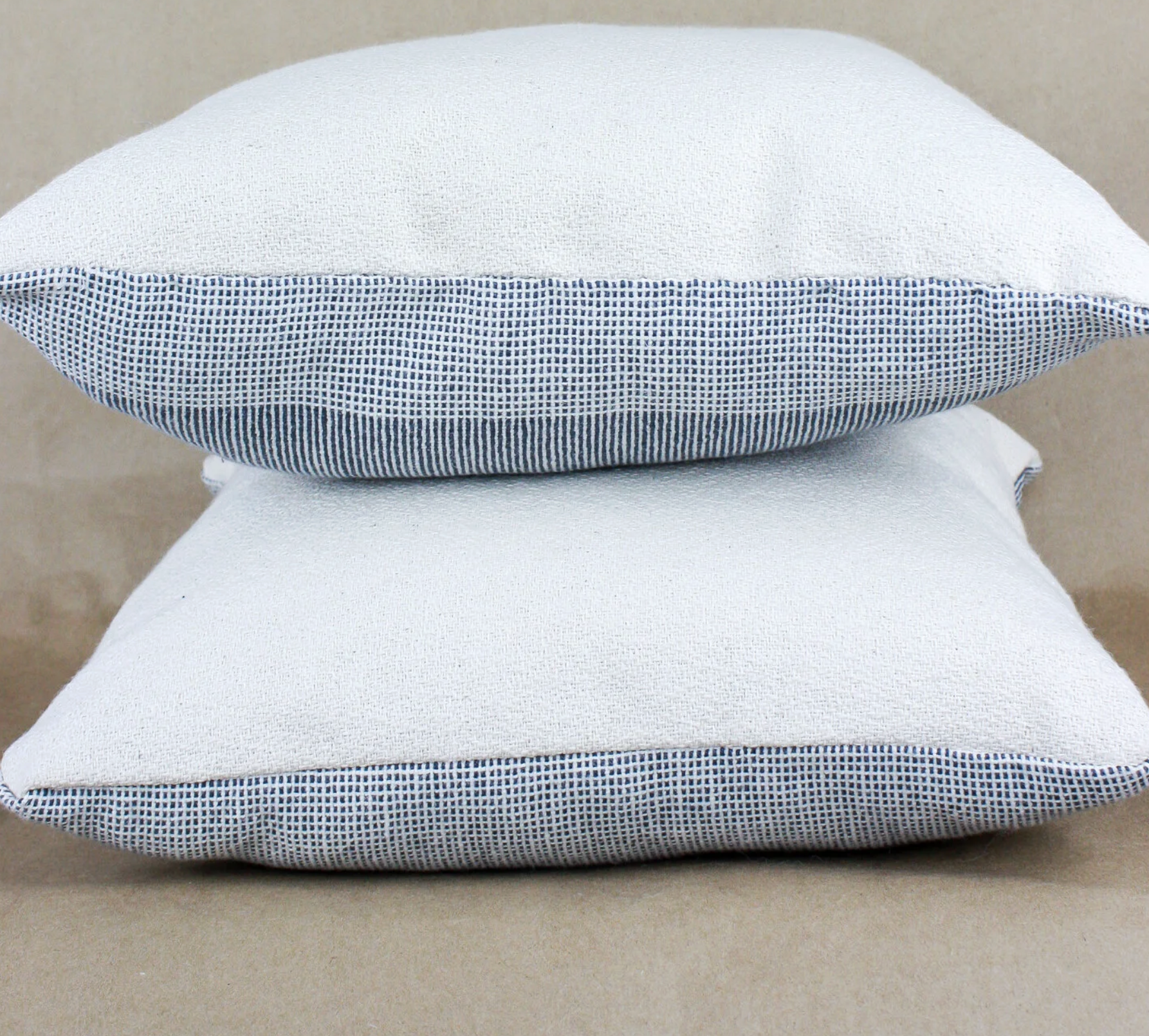Pillows with a patterned front and a white back.