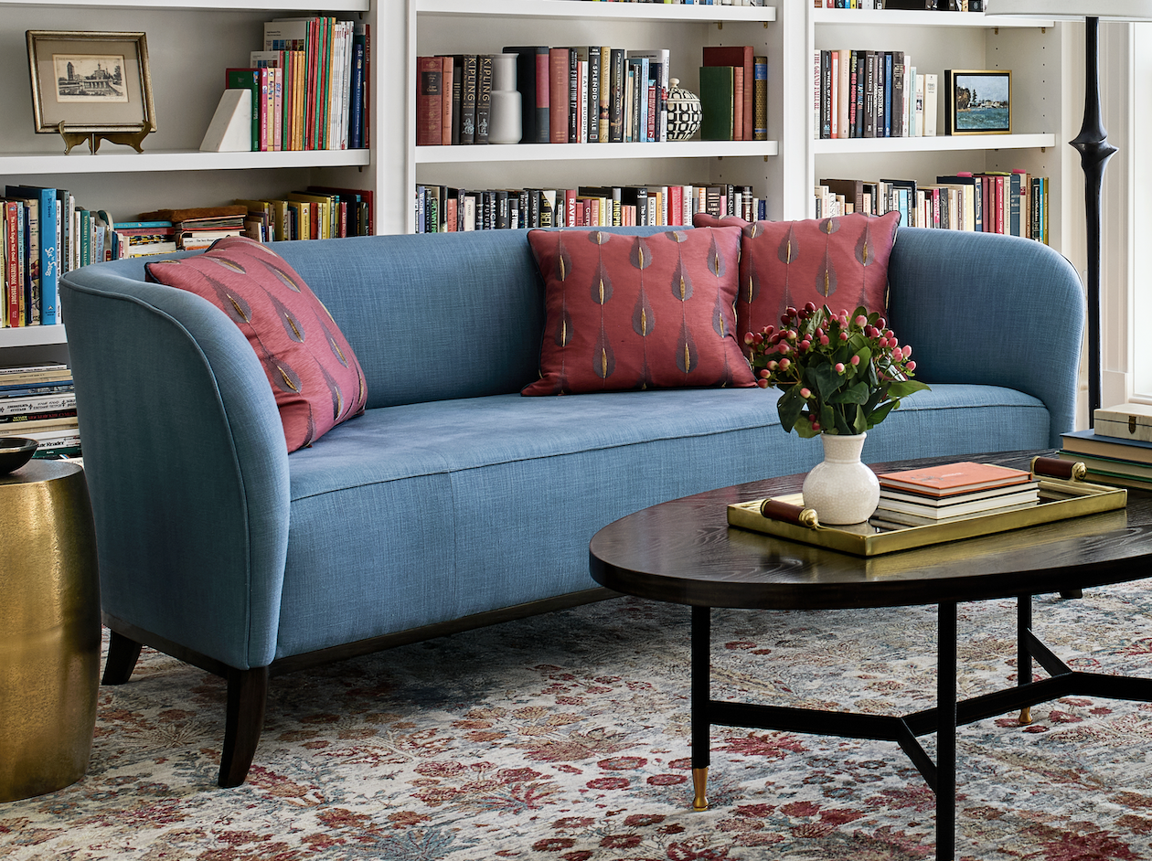 Red patterned pillows on blue sofa