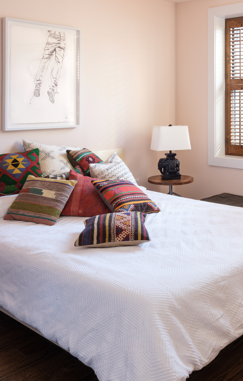 Pillows in different fabrics on bed