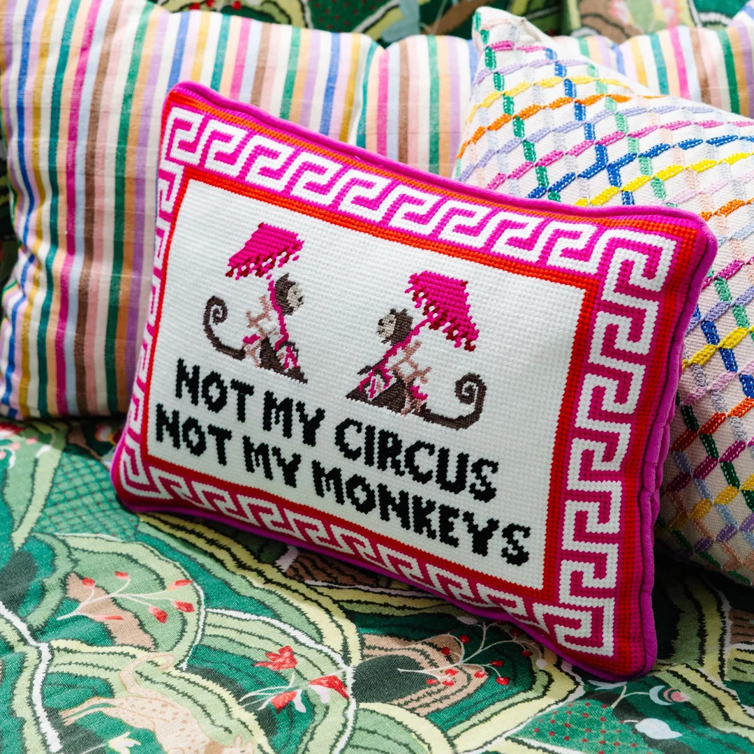 Needlepoint pillow that says "not my circus not my monkeys"