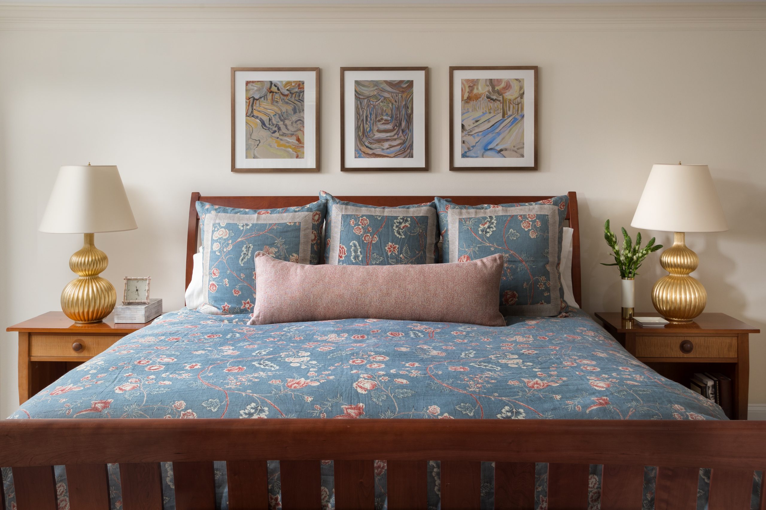 Bed with three square Euro pillows and one lumbar pillow