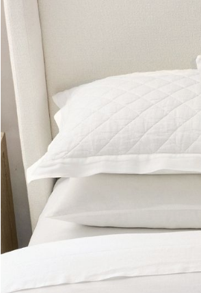 White pillows stacked on bed