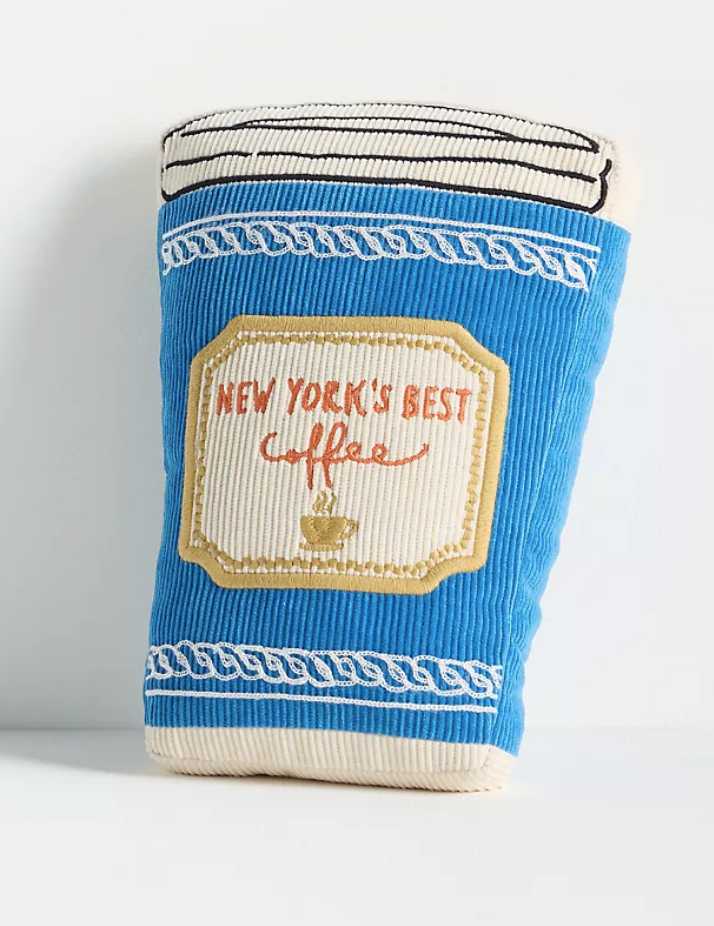 Whimsical accent pillow in the shape of a coffee cup