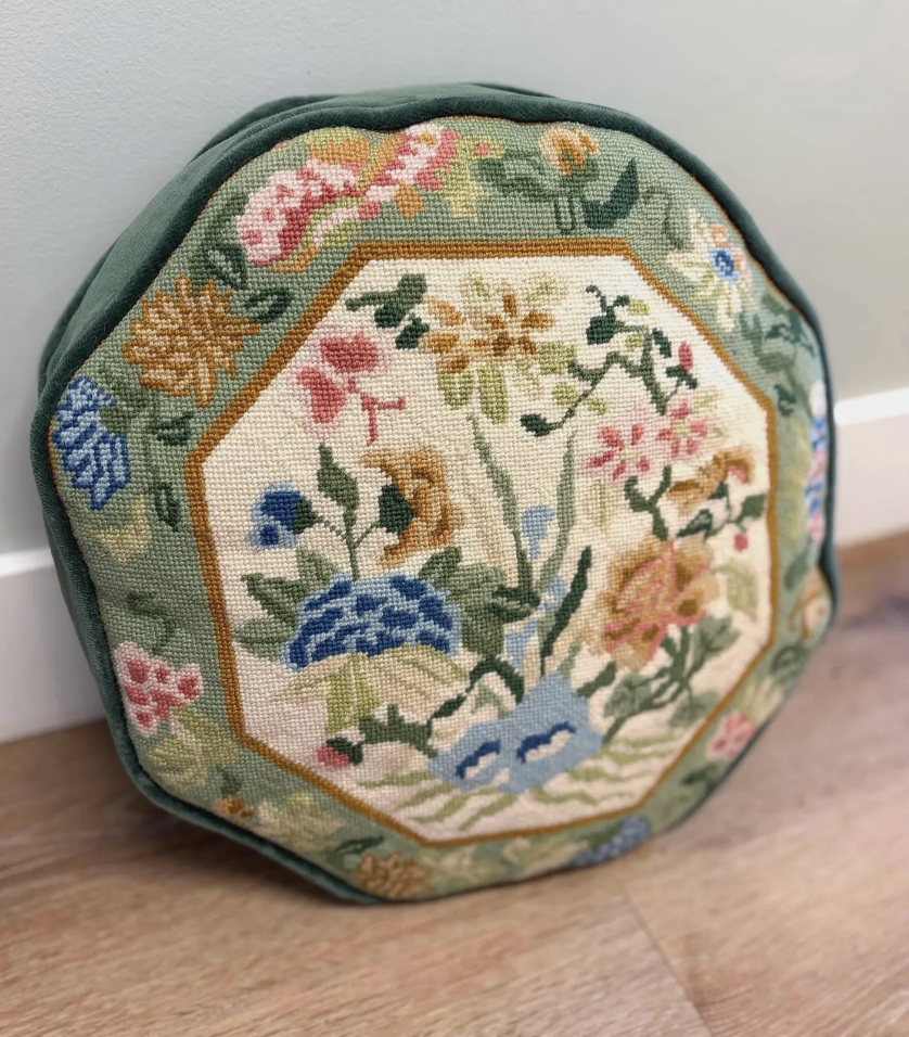 Whimsical round needlepoint pillow with flowers