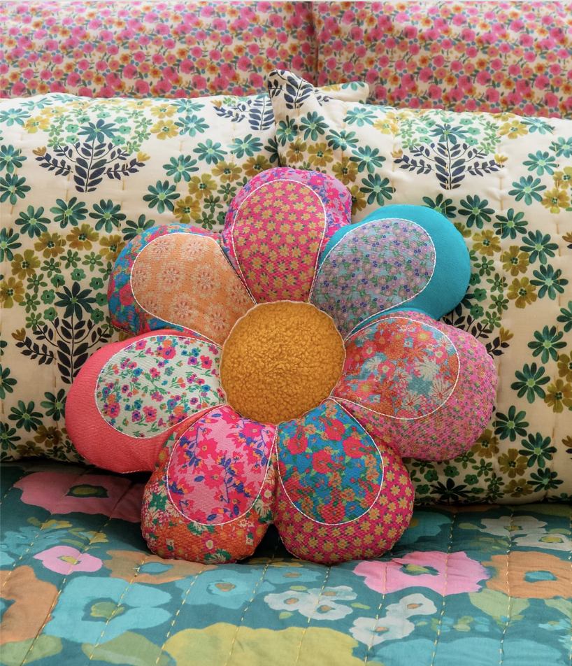 Whimsical bohemian colorful floral pillows on girl's bed